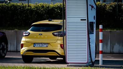 Gelber Ford Puma an einer Ionity-Ladesäule auf einem öffentlichen Ladeplatz.