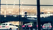 Blurred background with car dealership exterior. Abstract blurred photo of modern building motor showroom. Blur car show room office bokeh lights. Automobile retail shop